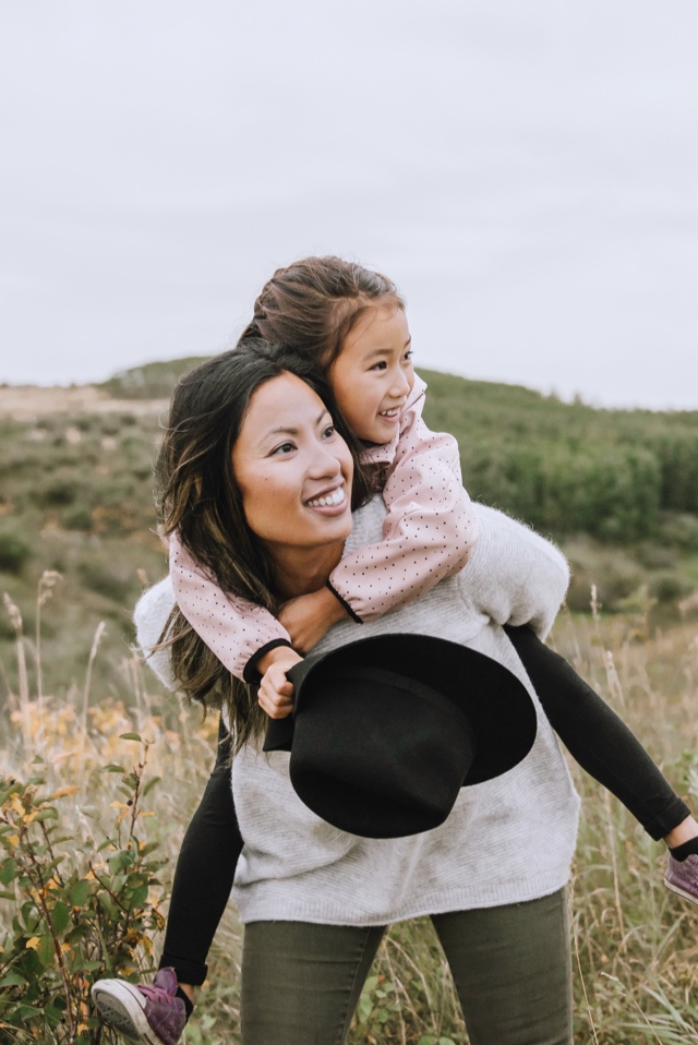 Daughter on her mothers shoulders.