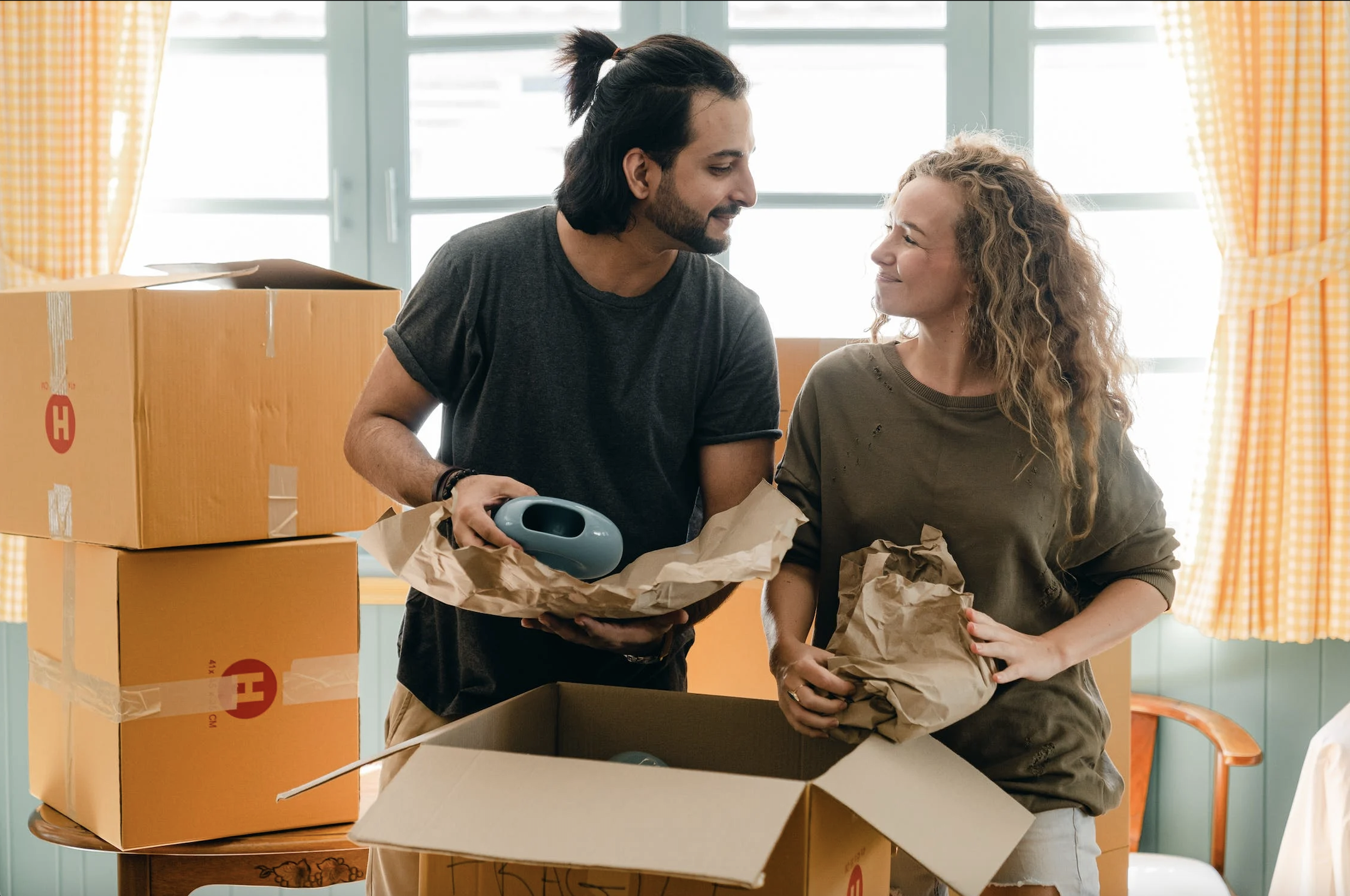 A couple unboxing their stuff as they move into their new home.