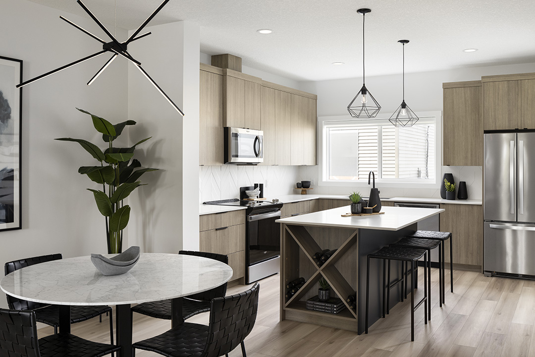 a kitchen with a table, chairs, and a refrigerator