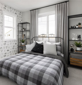 a bed with a white comforter and a window