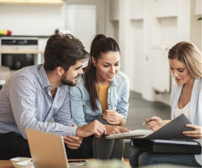 a woman and a man are working on a laptop