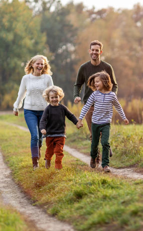 a family walks down a path with a child