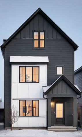 a house with a window and a large building