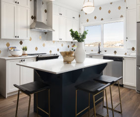 a kitchen with a sink, stove, and a counter top