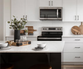 a kitchen with a stove, microwave, and dishwasher