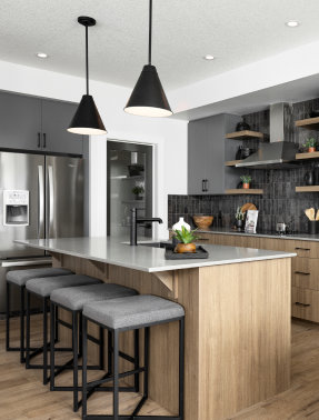 a kitchen with a stove, sink, and cabinets