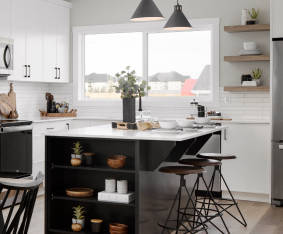 a kitchen with a stove, sink, and refrigerator