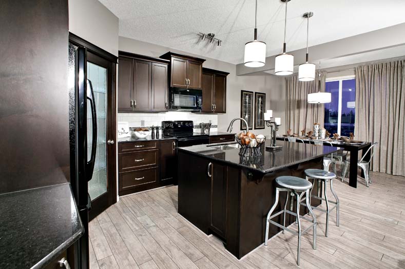 a kitchen with a stove, refrigerator, sink and a microwave