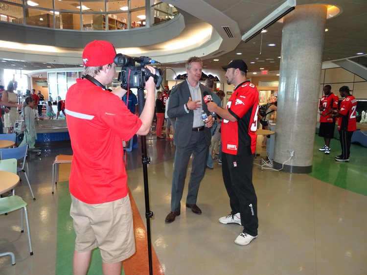 a man filming an interview with a stampeder