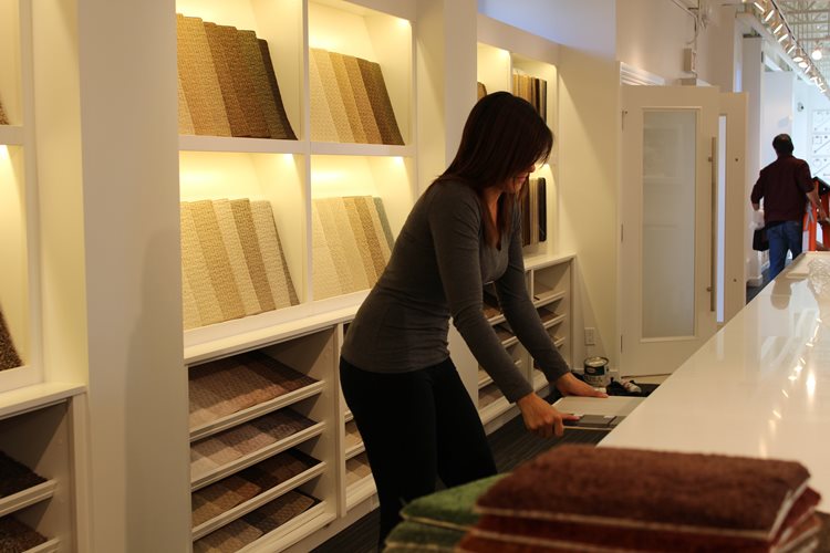 a woman standing in a store with a bunch of shelves