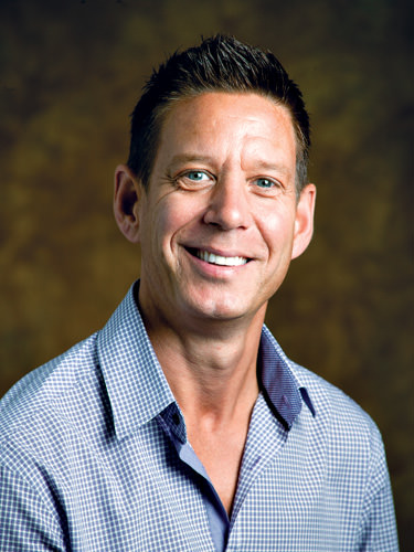 a man in a blue shirt smiling