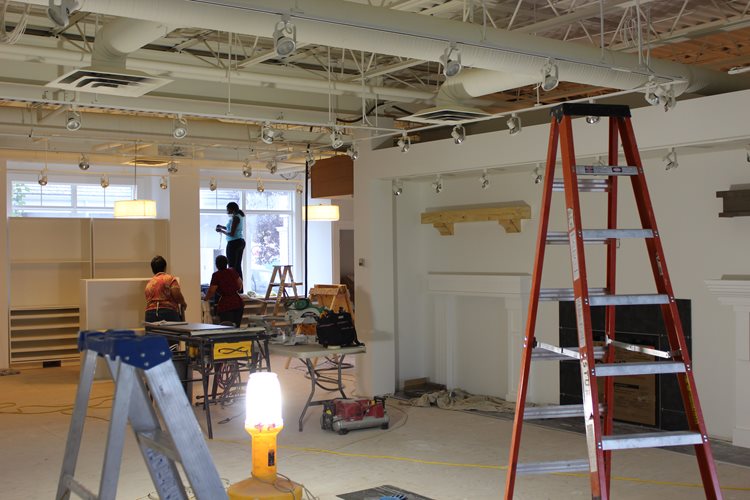 three people in a room under construction