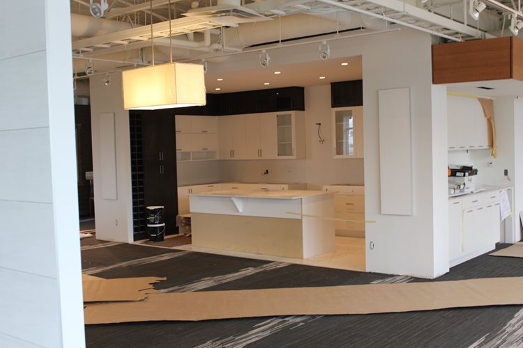 a kitchen with a refrigerator, sink, and a stove