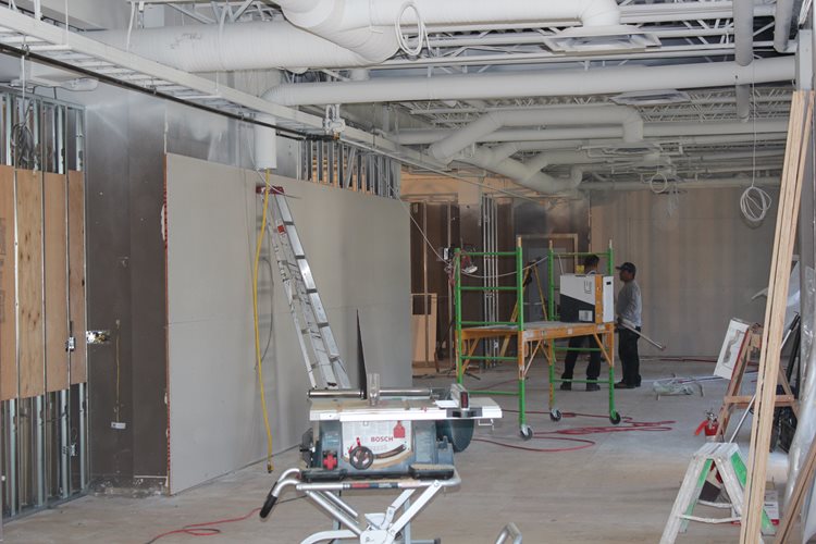 a man is working on a large wall