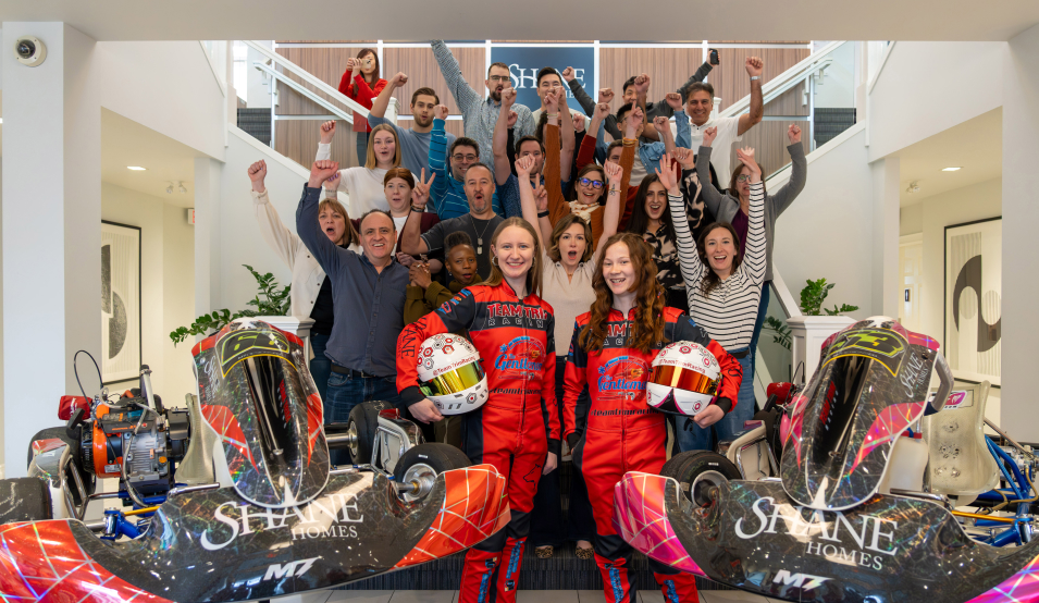 shane homes group photo raising hands