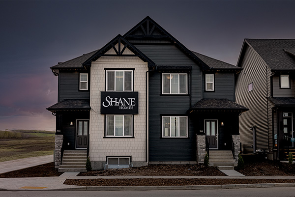 A black and white house featuring a sign that reads "Shane Homes"