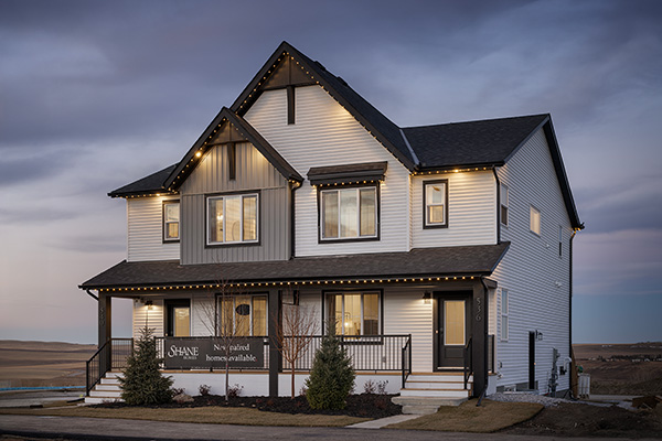 A two-story house featuring a front porch and a welcoming entrance.