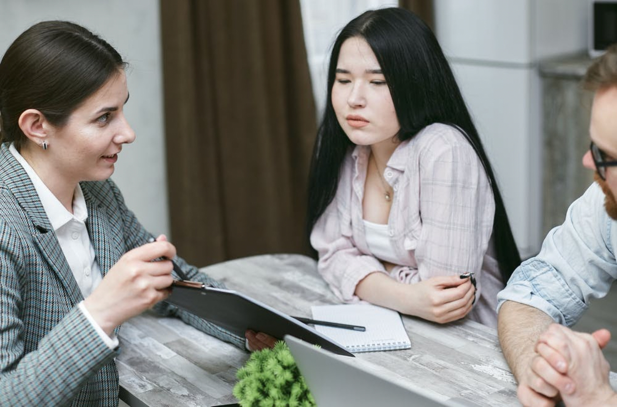 Couple meeting with a lender to obtain a mortgage.