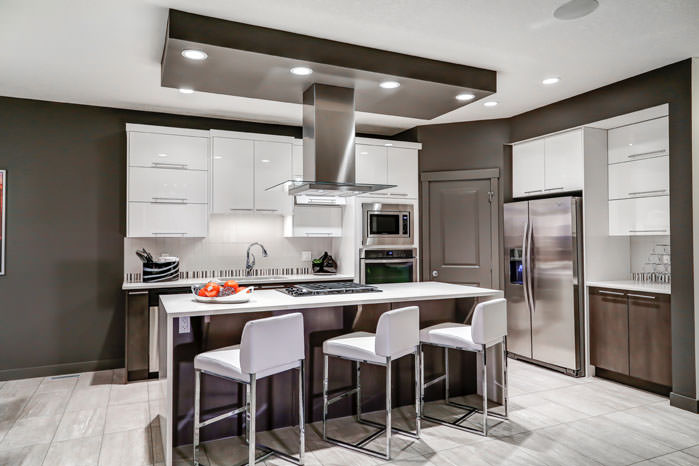 a kitchen with a refrigerator, sink, and a table