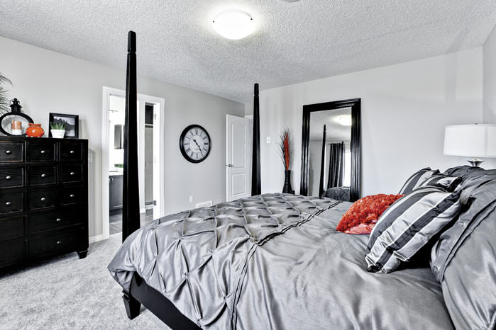 a bed with a white bedspread and a black head board